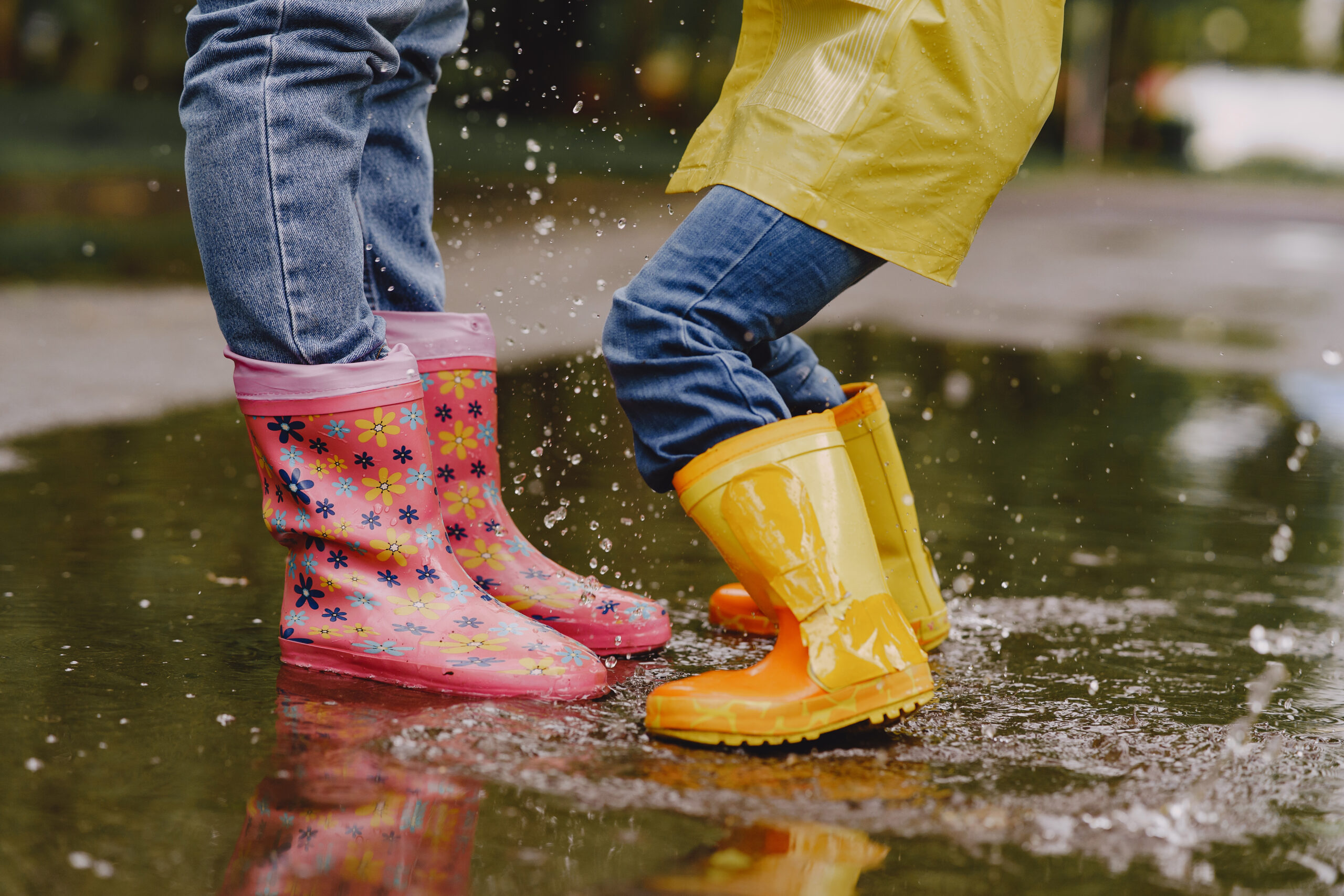 Funny kids in rain boots playing with paper ship by a puddle funny kids in rain boots playing with paper ship by puddle scaled - Funny kids in rain boots playing with paper ship by a puddle